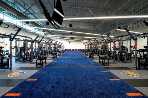 A blue turf strip runs through the center of the weight room in the Pascucci Team Center