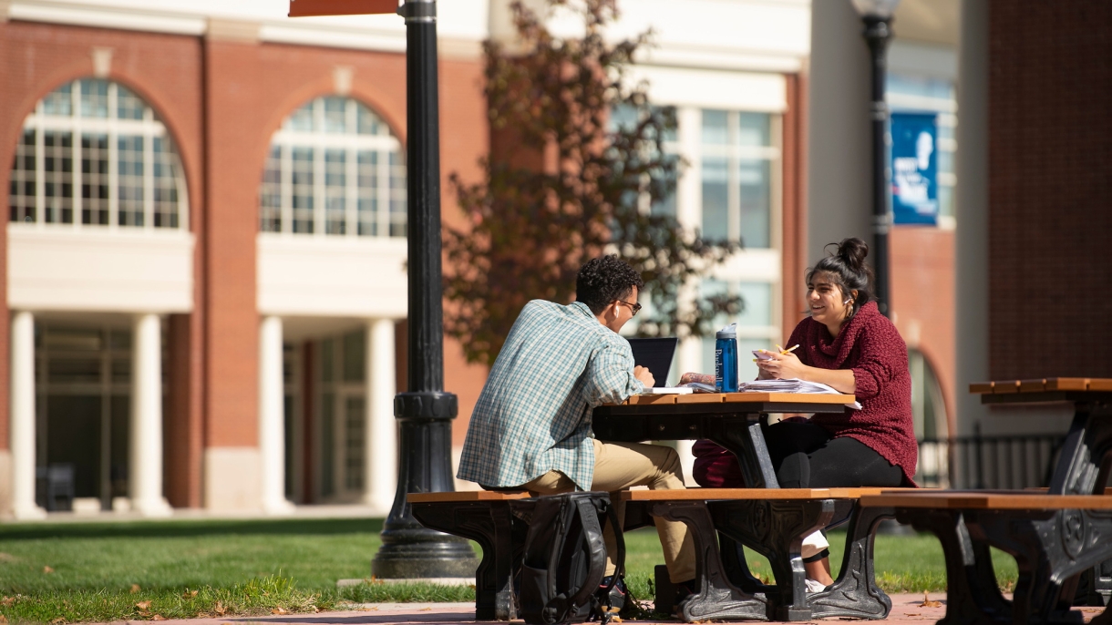 Students studying on a picnic bench