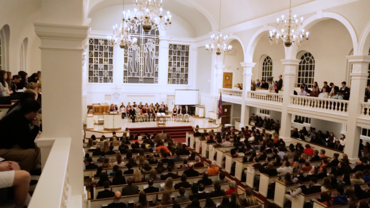 Diverse group sitting in chapel. 