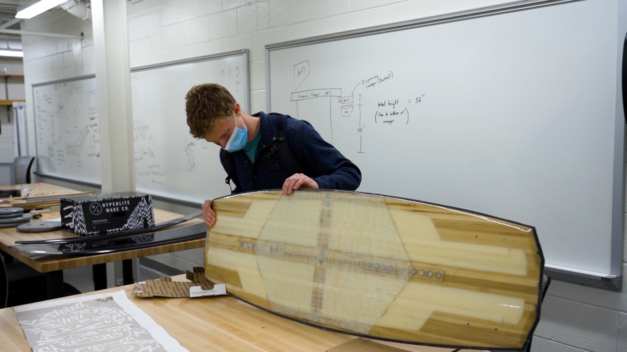 A student works on a wakeboard in an engineering lab