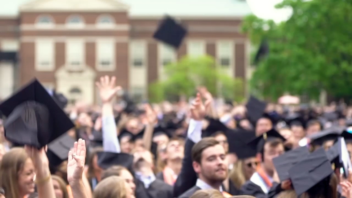 Bucknell graduates toss their caps in the air after Commencement