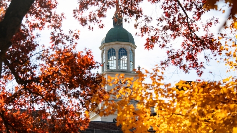The cupola of Bertrand Library is seen through yellow and red leaves