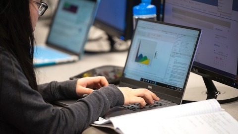 A student works on a graph on a laptop