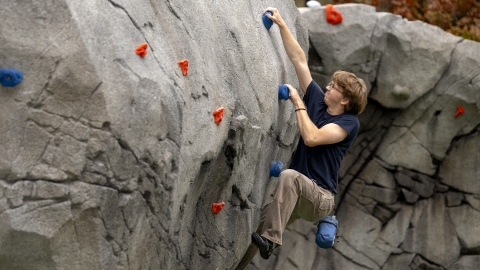 Student on a climb wall