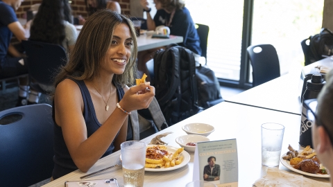 Student in cafe, sitting at the table, ready to eat