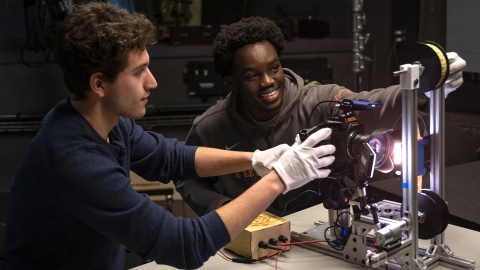 Two students working on a film preservation project