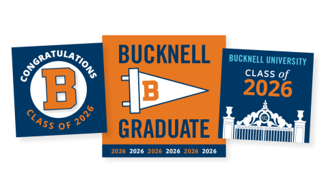 Three blue, orange and white food Toppers that say Bucknell Graduate, Class of 2026, and Congratulations Class of 2026
