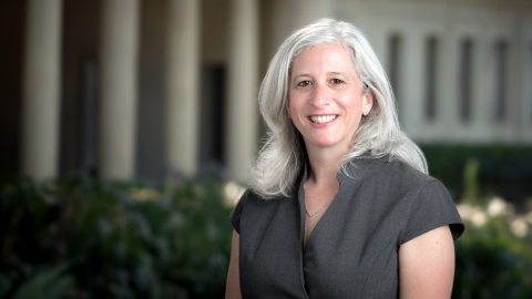 Portrait of Wendy Sternberg from the waist up. She is wearing a gray blouse.