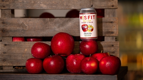Detail photo of Misfit cider can on stack of apples