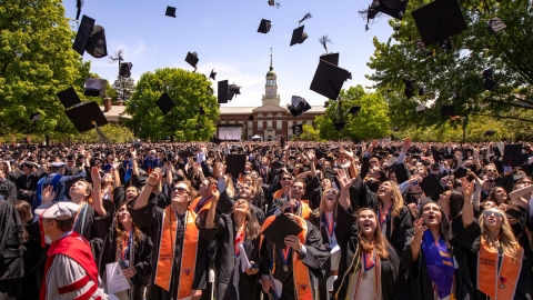 Hundreds of graduates on Malesardi Quadrangle throw their caps to celebrate their commencement