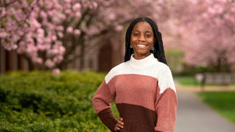 Deborah Gonkpah '26 poses against a backdrop of cherry blossoms