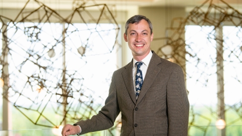 Daniel Street wears a brown suit and smiles