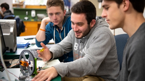 Students in mechanical engineering classroom.