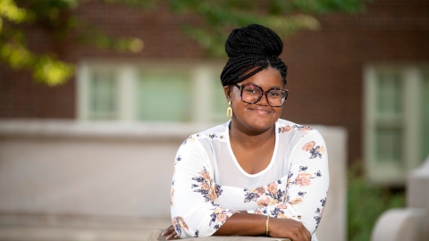 Portrait of Allure Cooper '23 leaning on wall