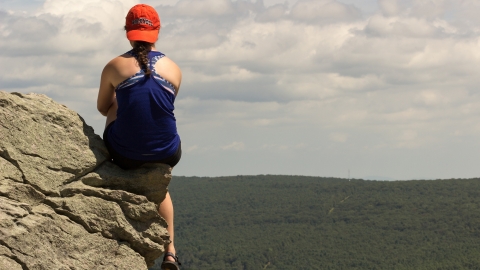 Bucknell student on rocky overhang