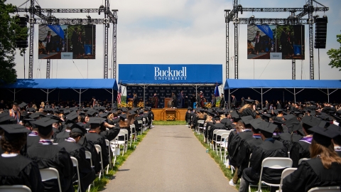 Wide shot of Class of 2019 graduates and the commencement stage on Malesardi Quad