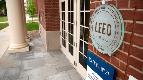 A plaque near the doorway into Academic West that reads LEED Platinum 2020