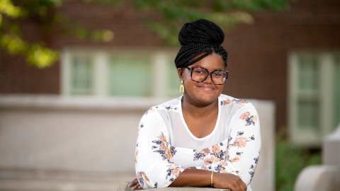 Portrait of Allure Cooper &#039;23 leaning on wall