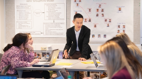 Professor Eddy Ng talks to students in management class