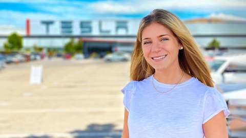 Caitlin D'Abrosio outside Tesla's Silicon Valley headquarters