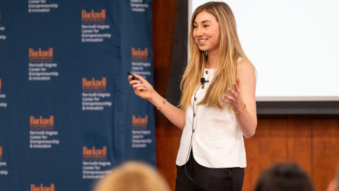 Anna Ottman smiles while addressing an audience.