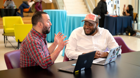 Tony Gomez and Kenneth Scott Jr. sit in Holmes Hall and talk
