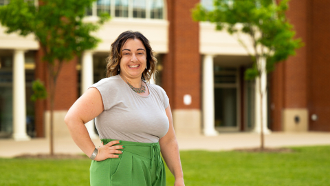Vanessa Massaro stands outside with one hand on her hip