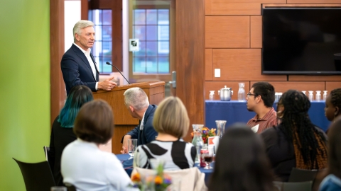 Bob Gamgort addresses students at a dinner.