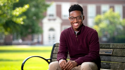 Quentin Andrews sits on a bench on Bucknell&#039;s campus.