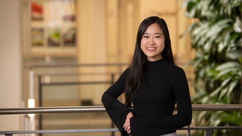 Wutt Kyi '22 poses against indoor railing