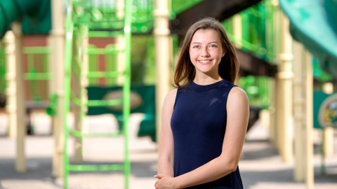 Brooke Ewer stands outside on a playground.