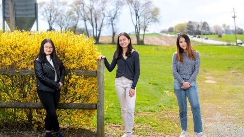 Student researchers pose at farm