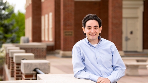 Gabe Gross leans on a railing on Malesardi Quad outside Marts Hall.