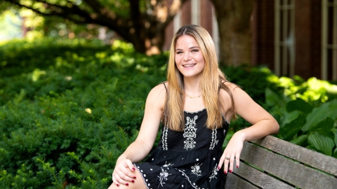 Portrait of student Hannah Sieg sitting on a bench