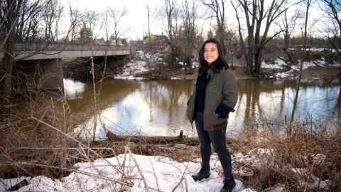 Lam Ngo ’22 stands by a tributary of the Susquehanna River in Lewisburg in winter
