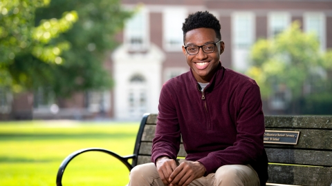 Quentin Andrews sits on a bench on Bucknell's campus.