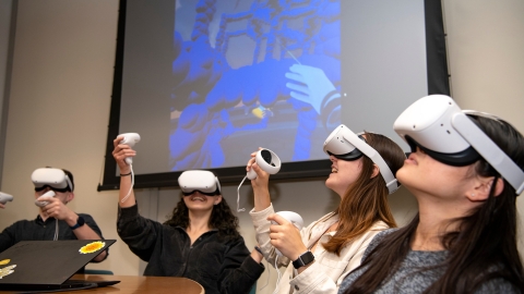 Students use Oculus headsets to looks at molecules.