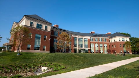 Exterior of the building Holmes Hall on a blue sky day