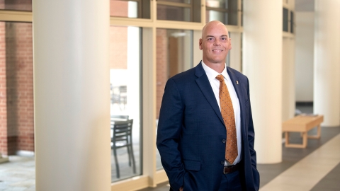 Portrait of Brad Putman in a suit inside Academic East