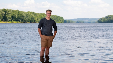 Kit Jackson stands ankle deep in the Susquehanna River