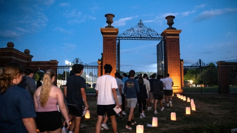 Students enter the Christy Matthewson Gates at twilight