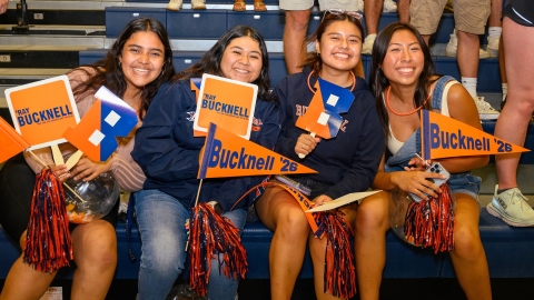 Students hold up Bucknell spirit signs during Orientation