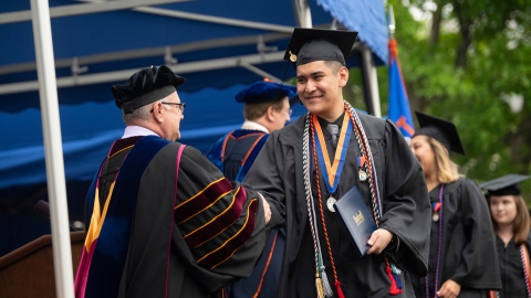 Student with diploma during Commencement