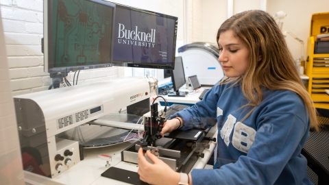 Student using a microscope in Maker-E