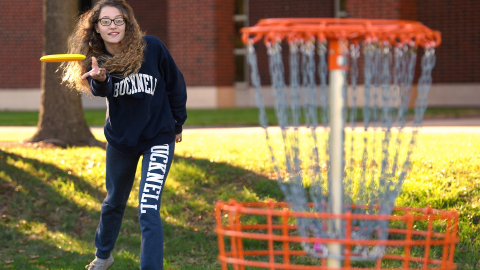 Student playing disc golf
