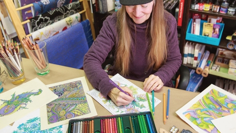 Artwork and supplies laid out across a table