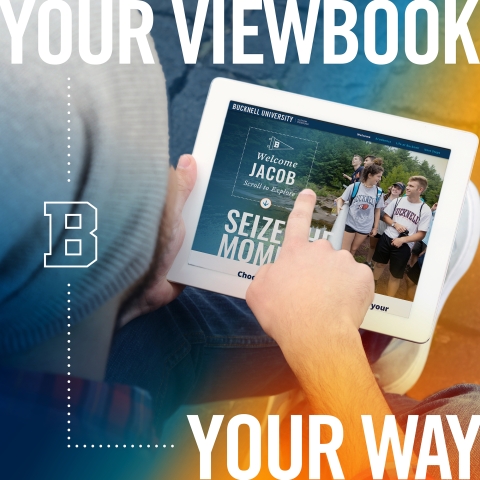A male student views a custom viewbook on a tablet and points at the screen
