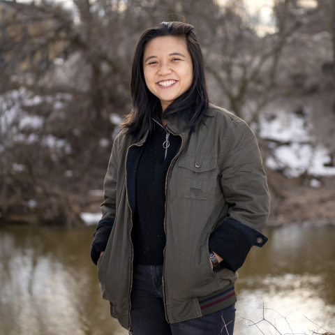 Lam Ngo ’22 stands by a tributary of the Susquehanna River in Lewisburg in the winter