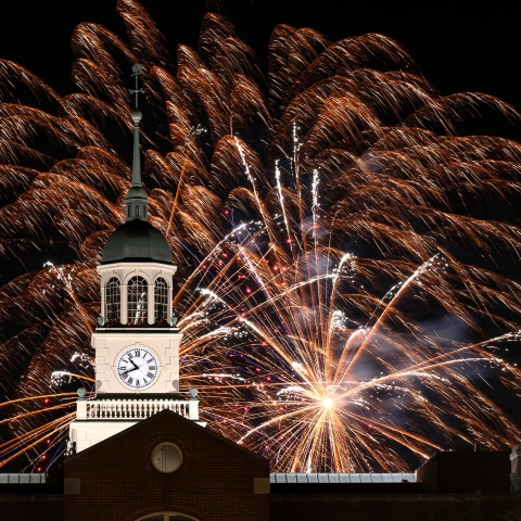 Fireworks explode over the clock tower at Bertrand Library during the night. 