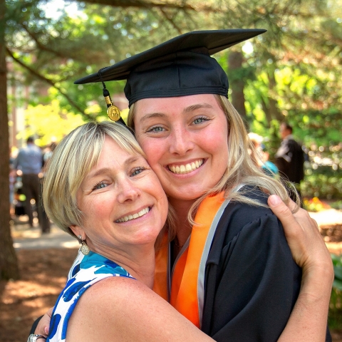 Parent and gradutate hugging at Commencement 2023